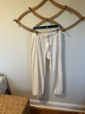 Tory Sport Cream Velour Track Joggers with green strip detail down the leg.